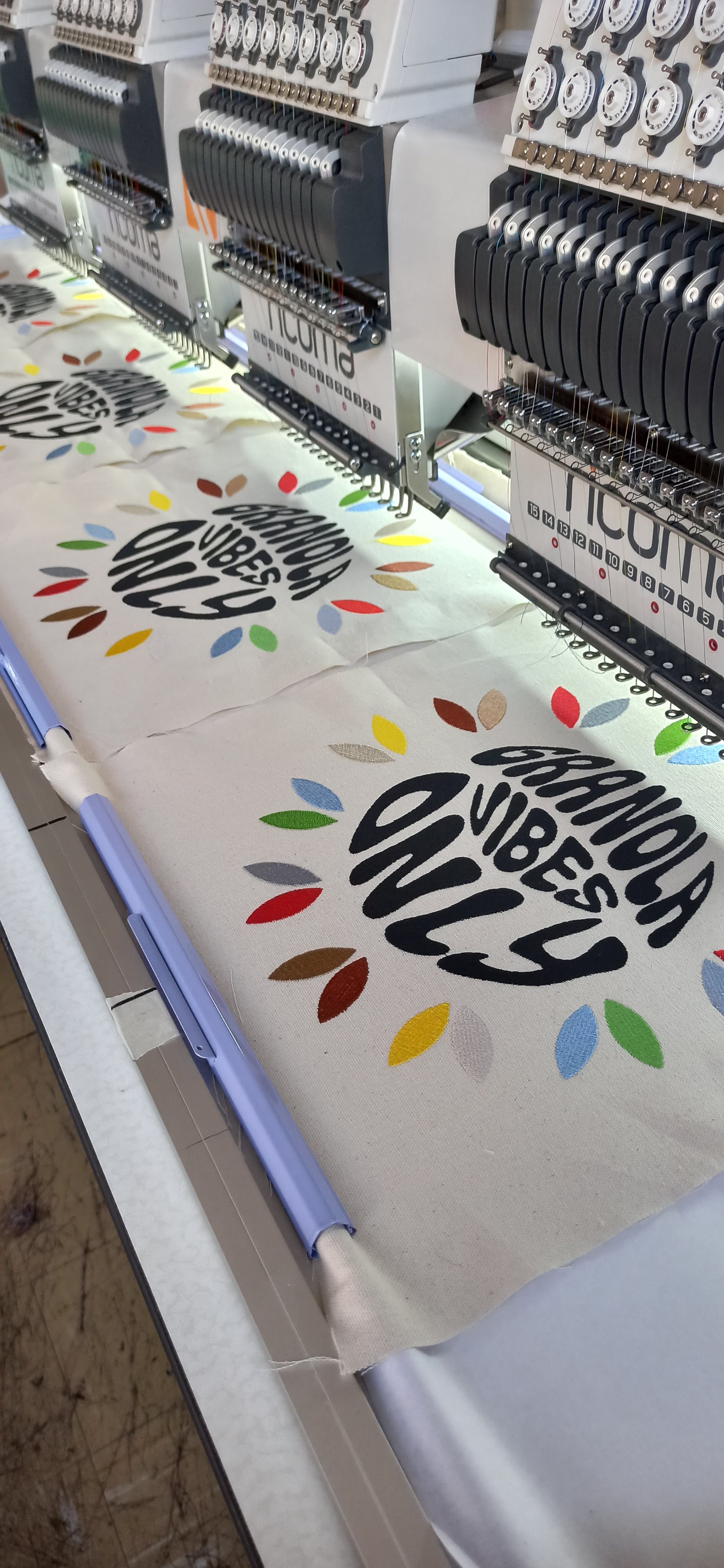 "Granola vibes only" being embroidered onto a bag