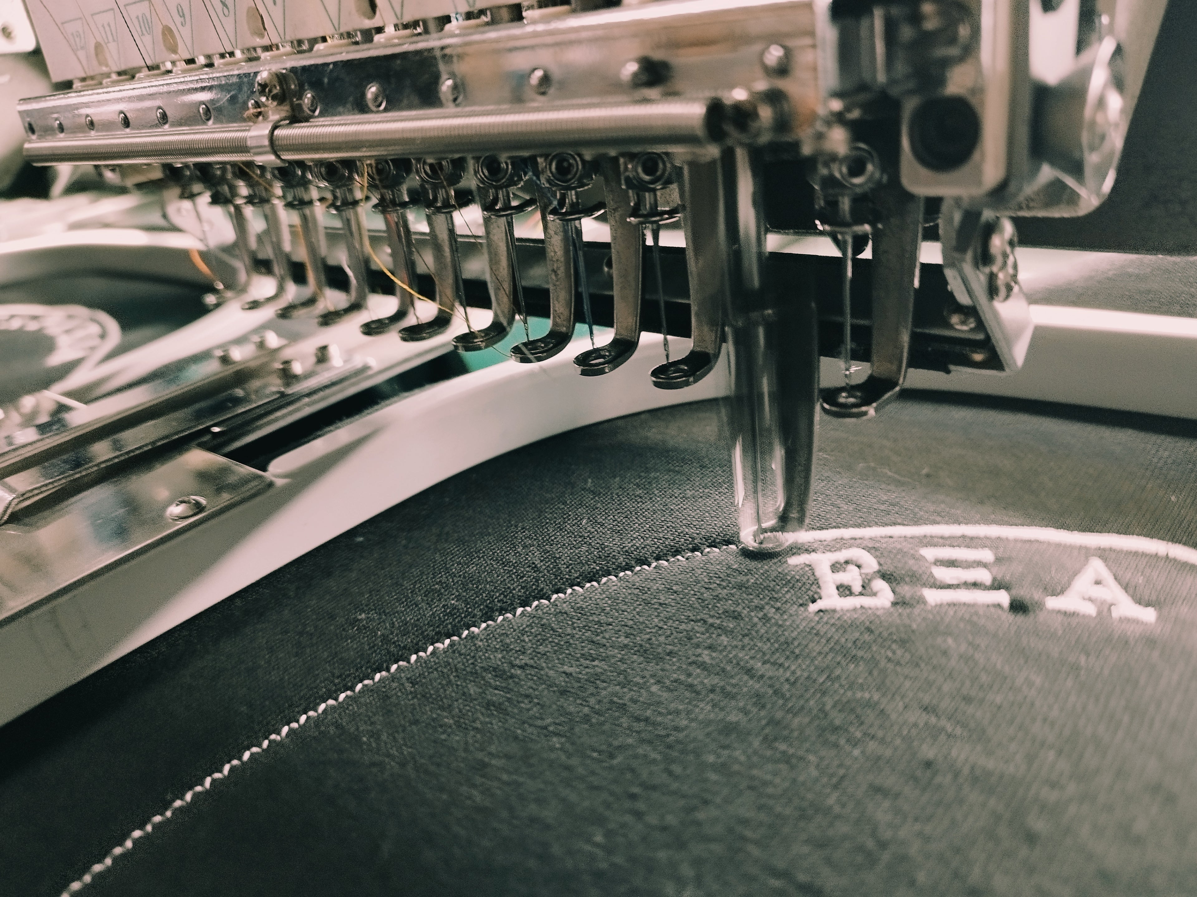 Logo being embroidered onto a shirt or cloth