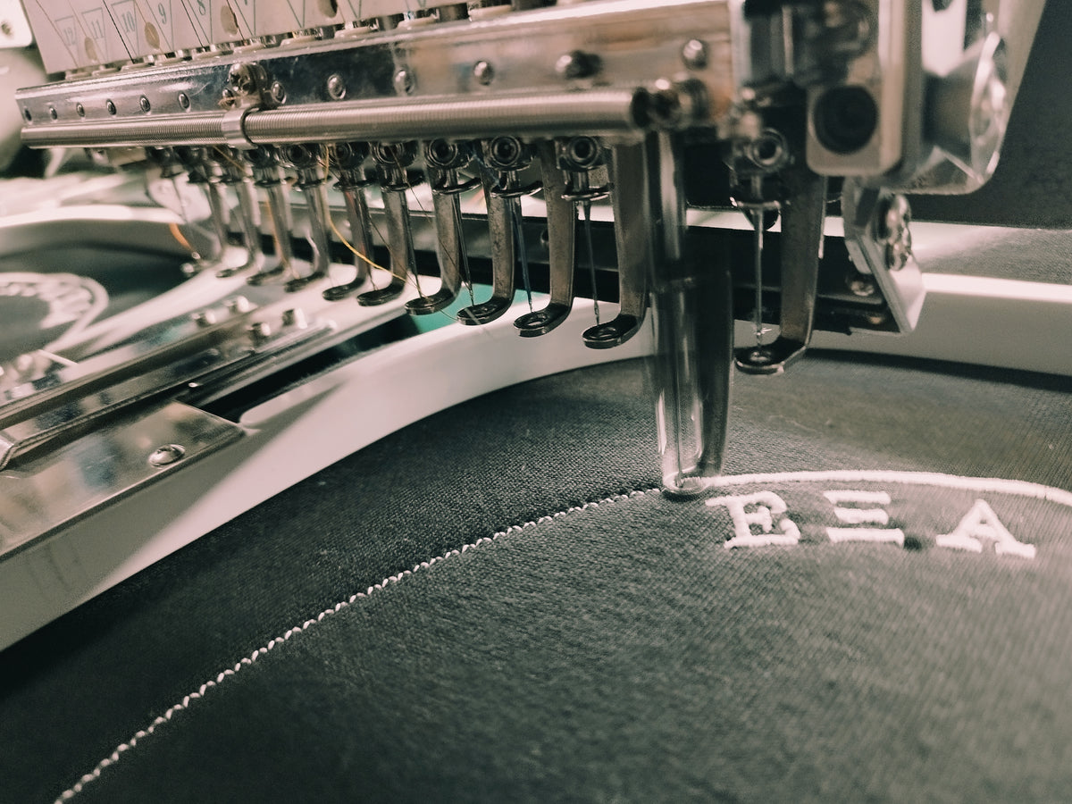 Logo being embroidered onto a shirt or cloth
